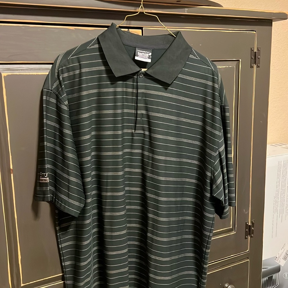 Black Nike golf shirt with Toyota financial services on right sleeve